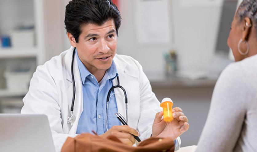 Woman Examined Pill Bottle while Smoking Cigarette